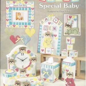 May include: A 16-piece plastic canvas nursery set with a Beary Special Baby theme. The set includes a clock, a tissue box cover, a bottle holder, a picture frame, a baby's den sign, and blocks. The set is designed by Diane T. Ray.