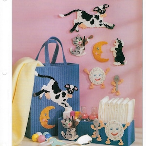 May include: A plastic canvas craft project featuring a tote bag, a diaper caddy, and various wall decorations. The decorations include a cow, a cat playing a violin, a moon, a sun, and a stick figure. The tote bag and diaper caddy are blue with white stripes. The decorations are all white with black details. The title "HEY DIDDLE, DIDDLE" is at the top of the image.