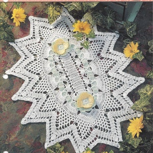 May include: White crochet doily with a pineapple design. The doily is laid on a brown surface with yellow flowers around it. The text "Pineapple Treasures" is at the top of the image. The text "Reflections" is at the bottom of the image.