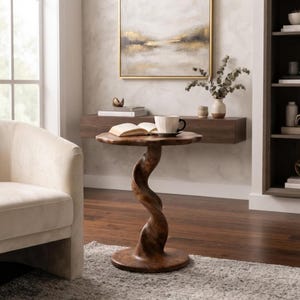 May include: A round wooden side table featuring a distinct, spiraling, twisted pedestal base that connects to a circular tabletop. The wood has a rich, medium-brown finish with visible grain patterns, standing on a flat, circular base.