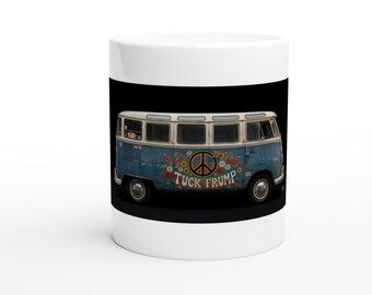 May include: A white ceramic mug featuring a graphic of a blue vintage van on a black background. The van is decorated with colorful flowers and a peace sign, with the text TUCK FRUMP printed in a stylized font across the side of the vehicle.