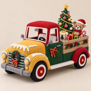 May include: A crocheted toy truck with a red roof, yellow hood, and green body. The truck bed carries a crocheted Christmas tree, a teddy bear in a Santa hat, and wrapped gifts. A wreath is attached to the front grille.