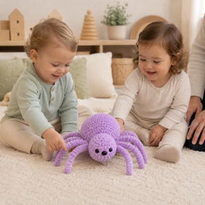 May include: A plush, crocheted spider toy in a vibrant lavender color. The spider features a round, textured body, eight long, segmented legs, and three small, dark, circular eyes positioned on the front of its head, crafted from soft yarn.