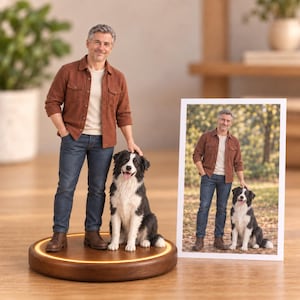 May include: A custom 3D figurine of a person with gray hair wearing a rust-colored button-down shirt, white t-shirt, and blue jeans, standing next to a black and white border collie on a circular wooden base with a glowing light ring.