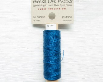 May include: A spool of Weeks Dye Works 2-Strand cotton floss in a vibrant blue colour. The label reads "COLORFAST" and "45 Yards". The product is labelled F2-1307. The floss is wound around a cardboard tube.
