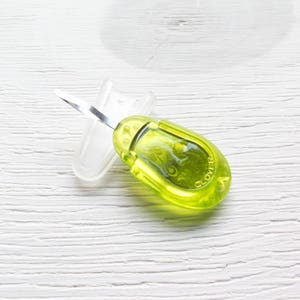 May include: A lime green Clover thread cutter with a silver blade and a clear plastic blade cover. The tool has a rounded, ergonomic design and is designed for cutting threads in sewing and crafting projects.