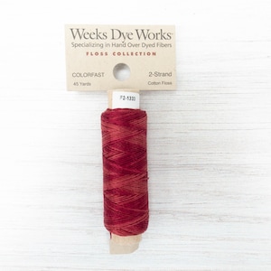 May include: A spool of red and brown cotton floss from Weeks Dye Works. The label reads "COLORFAST" and "2-Strand Cotton Floss." The spool contains 45 yards of thread. The product code is F2-1333.