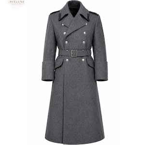 May include: A charcoal gray double-breasted long coat featuring a wide notched collar with black accents, silver-toned buttons, a matching waist belt with a rectangular buckle, and deep cuffs. The garment has a structured, full-length silhouette.