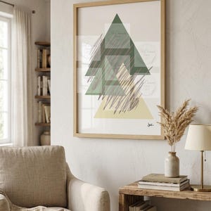 May include: A framed wall art print featuring a geometric composition of overlapping triangles in shades of dark green, light green, and pale yellow, accented by dark grey scribbled lines and a small signature in the bottom right corner.