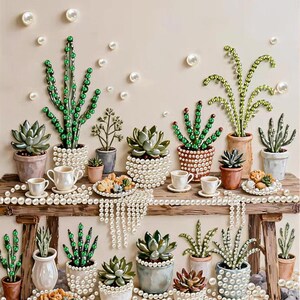 May include: A collection of potted succulents and cacti decorated with green beads and white pearls, arranged on and around a wooden bench. The display includes small white cups, plates with food, and scattered white pearls on the surface.