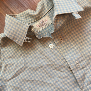 May include: A blue and white gingham button-down shirt with a label that reads "417 Van Heusen" and "15-16 1/2".