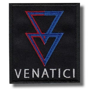 May include: A square black embroidered patch featuring a central graphic of two stacked triangles, with the left side in red and the right side in blue. Below the triangles, the word VENATICI is stitched in white capital letters.