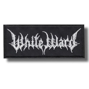 May include: A rectangular black embroidered patch featuring the white text White Ward in a stylised, jagged, and sharp-edged font. The patch has a solid black background with a thick black border, creating a high-contrast design.