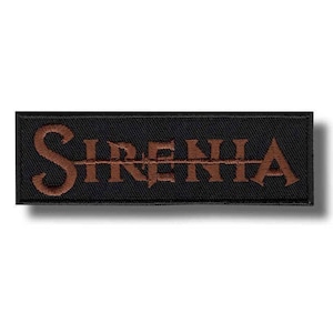 May include: A rectangular black embroidered patch featuring the word SIRENIA stitched in a bold, copper-brown serif font. The letters are arranged horizontally across the centre of the fabric, which has a visible woven texture and a stitched border.