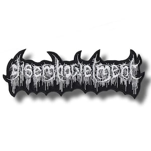 May include: A black embroidered patch featuring white text that reads disembowelment in a stylized, jagged font. The lettering has a dripping, vine-like effect extending downward, and the patch has a contoured, irregular border shape.