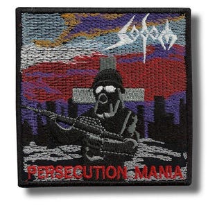 May include: A square embroidered patch featuring a soldier in a gas mask holding a rifle in front of a cross. The background shows a red and purple sky over a dark cityscape. The text Sodom is at the top and Persecution Mania is at the bottom.