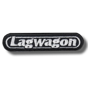 May include: A rectangular embroidered patch with rounded corners featuring a black background and a white border. The word Lagwagon is stitched in white, bold, sans-serif capital letters across the center of the patch, creating a high-contrast design.