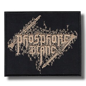 May include: A rectangular black embroidered patch featuring the text Phosphore Blanc in a stylised, jagged font. The lettering is surrounded by an intricate, light-coloured barbed wire design that extends diagonally across the fabric surface.