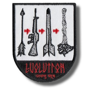 May include: A shield-shaped embroidered patch with a white background and black border. It features a sequence of an arrow, a rifle, a missile, and a mushroom cloud, connected by red arrows. The word EVOLUTION is stitched in red at the bottom.