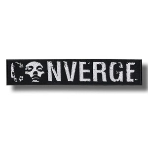 May include: A rectangular black embroidered patch featuring the white text CONVERGE in a distressed, weathered font. The letter O is replaced by a stylized white human skull graphic. The patch has a clean, stitched border around the edges.