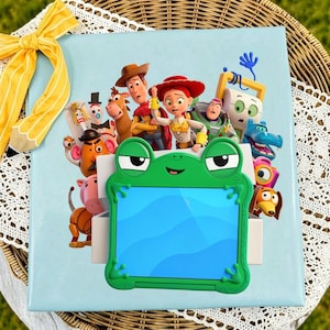 May include: A light blue square box featuring a colorful graphic of Toy Story characters including Woody, Jessie, and Buzz Lightyear. A bright green frog-shaped tablet case with a blue screen is centered on the front of the box.