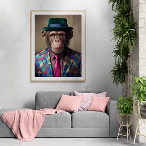May include: A framed wall art print depicting a chimpanzee wearing a dark green fedora with a blue band, a maroon dress shirt, a bright pink necktie, and a blazer featuring a colorful geometric pattern of blue, yellow, and red cubes.