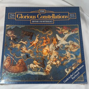 May include: A square jigsaw puzzle box titled The Glorious Constellations History and Mythology. The dark blue box features an illustration of various mythological figures and animals in a starry sky, measuring 20 inches by 27 inches.