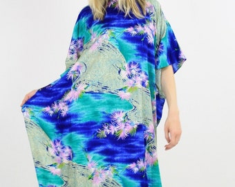 May include: A long, flowing blue, green, and white maxi dress with a floral print. The dress has a loose, comfortable fit and is perfect for a summer day.