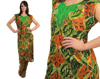 May include: A long, sleeveless dress with a green and orange batik print. The dress has a V-neckline and a small green embroidered design on the front.