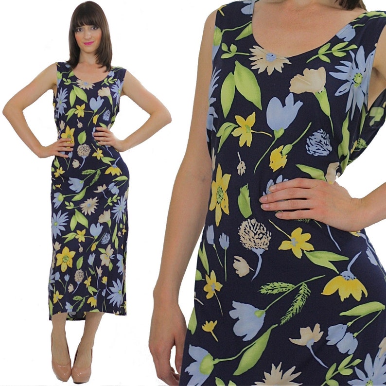 Pode incluir: Um vestido maxi sem mangas com estampa floral em tons de azul, amarelo e verde. O vestido tem um decote redondo e uma silhueta ajustada.