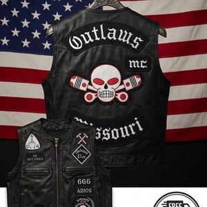 May include: A black leather waistcoat featuring embroidered patches. The back displays 'Outlaws MC', a skull with crossed pistons, and 'Missouri'. The front includes patches with '30 Seconds', 'Outlaws 1%er', '666', 'Adios', and a skull graphic.