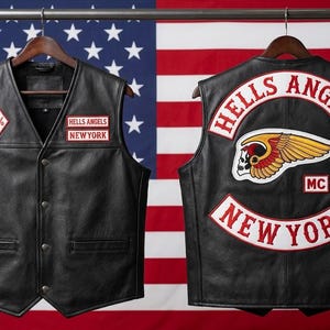 Può includere: Un gilet in pelle nera con toppe sul davanti e sul retro. Il davanti mostra una toppa a rombo 1% e una toppa Hells Angels New York. Il retro presenta un grande rocker Hells Angels, un emblema con teschio alato, una toppa MC e la scritta New York.