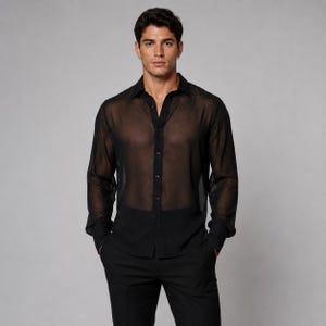 May include: A black long-sleeved shirt made of a sheer, translucent fabric. The shirt features a classic collar, a front button-down placket with matching black buttons, and long sleeves that end in structured cuffs. The garment has a straight hem.