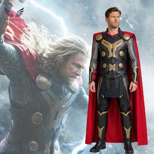 May include: A full-body costume featuring a black and gold chest plate with circular accents, silver chainmail-style sleeves, black trousers with gold knee details, and a long red cape. The outfit is worn by a person with short brown hair.