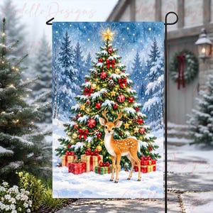 May include: A rectangular garden flag featuring a decorated Christmas tree with red and gold ornaments, a yellow star topper, and snow-covered branches. A fawn stands in the snow in front of the tree, surrounded by several wrapped gift boxes.