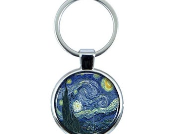 May include: A silver keychain with a round, blue and yellow image of Vincent van Gogh's "Starry Night" painting.
