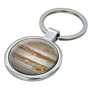 May include: A silver key ring with a round, silver-rimmed charm featuring a detailed image of Jupiter, the largest planet in our solar system.