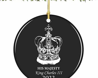 May include: Black and white Christmas ornament with a white crown and the text "His Majesty King Charles III 2022".