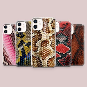 May include: Five smartphone cases arranged in a row, each featuring a distinct snakeskin pattern. The designs include pink, yellow and blue, brown and cream, red and black, and dark orange scales, all with cutouts for the camera lenses.
