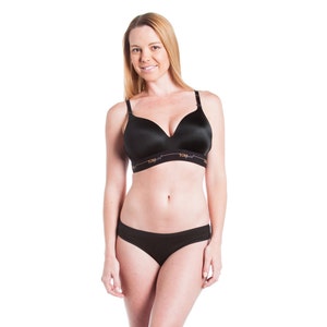 May include: A black seamless wireless bra with adjustable straps and a black thong underwear. The bra has the word "TOM" printed on the band.