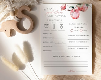 May include: A baby shower prediction and advice card with floral accents. The card includes sections for baby name, gender, date of birth, hair and eye color, and advice for parents. A wooden toy and decorative elements are also present.