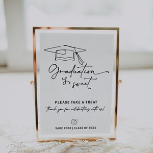 May include: A gold-framed sign with a white background and black text that reads "Graduation is sweet."  The sign also includes a black line drawing of a graduation cap and a small black and white illustration of a graduation cap with a tassel. The text "Please take a treat thank you for celebrating with us!" is also included on the sign. The sign also includes the text "SAGE ROSE | CLASS OF 20XX".