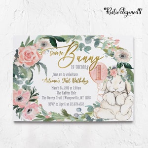 May include: A pink and green floral wreath with a white bunny holding a pink balloon with the number one on it. The text "Some Bunny is turning 1" is written in gold script. The text "Join us to celebrate Autumn's First Birthday" is written in black. The date, time, location, and RSVP information are also included.