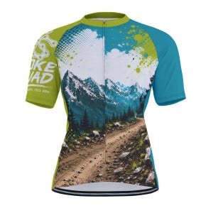 May include: A short-sleeve cycling jersey featuring a mountain landscape graphic with a dirt path, pine trees, and snow-capped peaks. The design includes lime green sleeves, a teal side panel, and the text "BIKE SQUAD" with "RIDE HARD, FEEL GOOD".