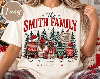 May include: An ivory crewneck sweatshirt featuring a graphic of five people sitting in front of pine trees. The text reads The Smith Family, Making Christmas Brighter Together, and Est. 2023. Names Dad, Mom, Emma, Liam, and Noah are printed below.