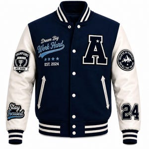 May include: A navy blue varsity jacket with white sleeves, featuring a large letter A on the chest, white snap buttons, and striped ribbed cuffs. Patches include text reading Dream Big Work Hard, EST. 2024, Champions Are Made Not Born, Stay Focused, Believe In Yourself, and the number 24.