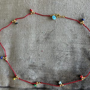 Collar gargantilla hilo rojo ojos turcos colores  en vidrio.