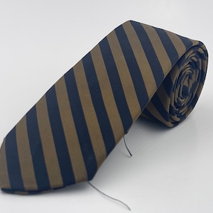 May include: A brown and black striped tie. The tie is rolled up and ready to be worn.