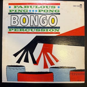 May include: Vintage vinyl record album cover for "Fabulous Ping Pong Bongo Percussion." The cover features bold text in blue, green, and black, with a graphic of stylized hands and bongo drums in red, black, and blue. The album is from Coronet Records.