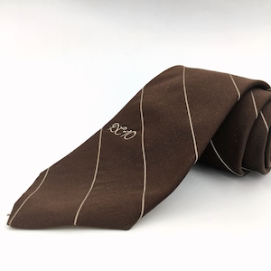 May include: A brown striped tie with a white stripe and the text "2:10" embroidered in white.